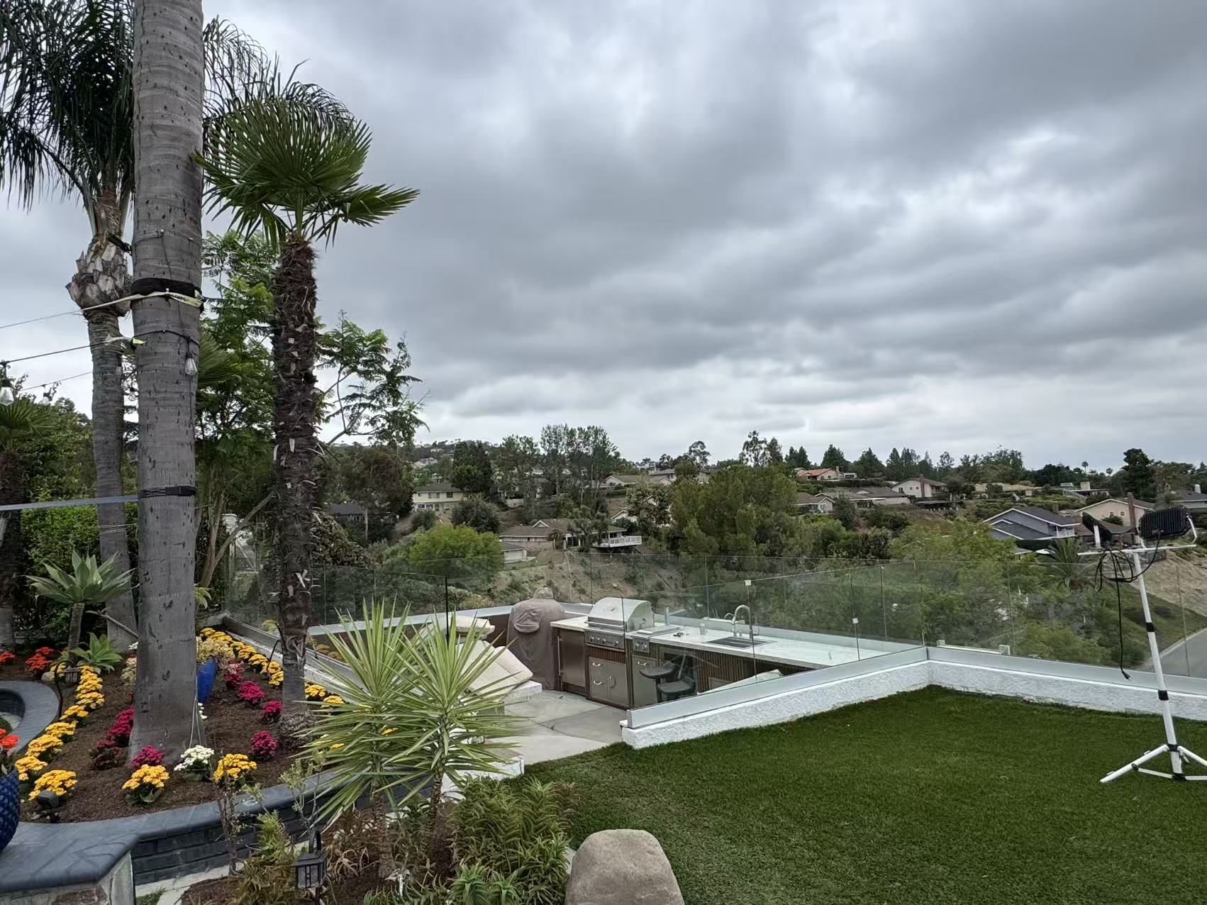 The original exposed hilltop yard in Anaheim before the pergola build — outdoor kitchen fully exposed to wind and sun