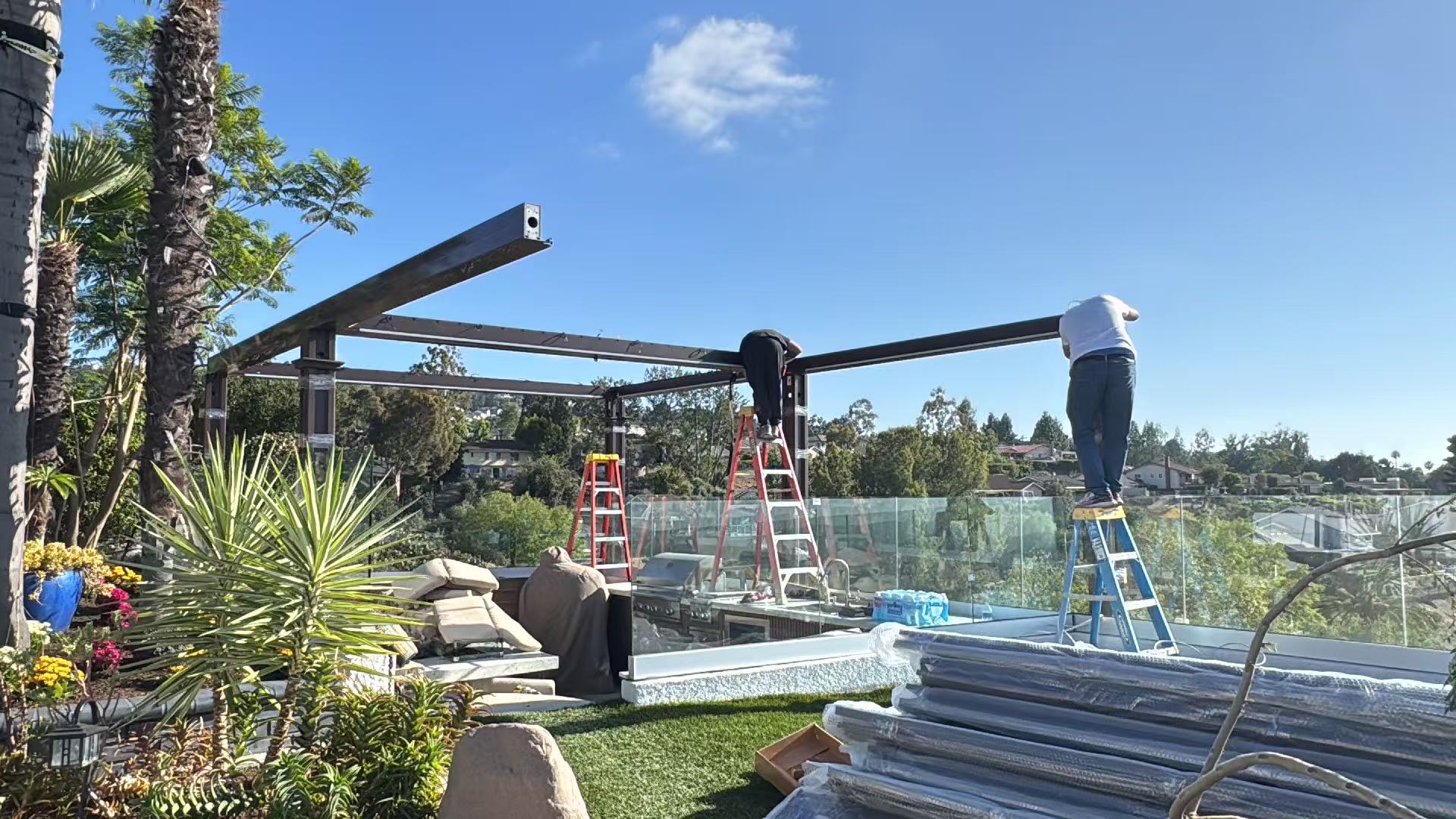 Luxora crew installing the powder-coated aluminum pergola frame on the hilltop terrace