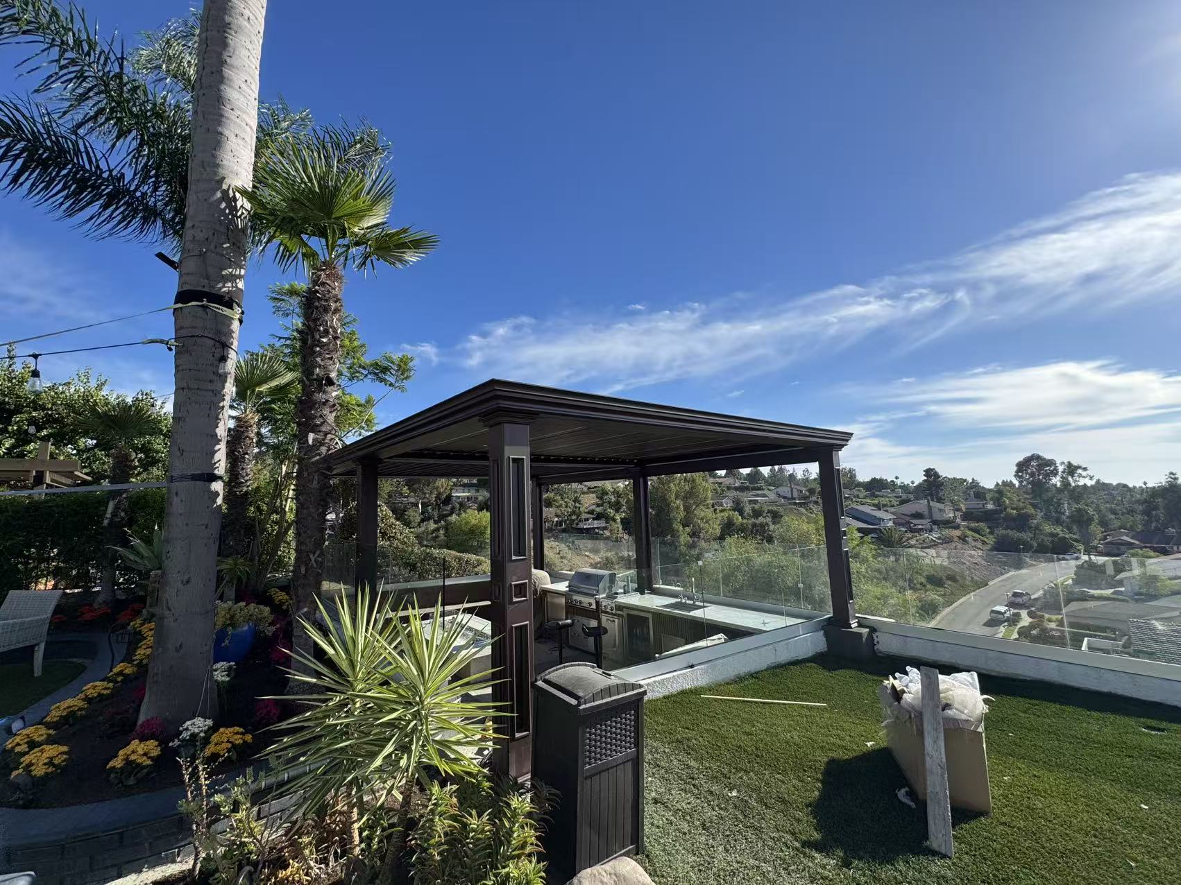 Corner elevation of the completed pergola with the frameless glass railing and canyon backdrop